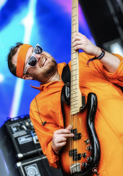 Taylor Shell performing with a bass